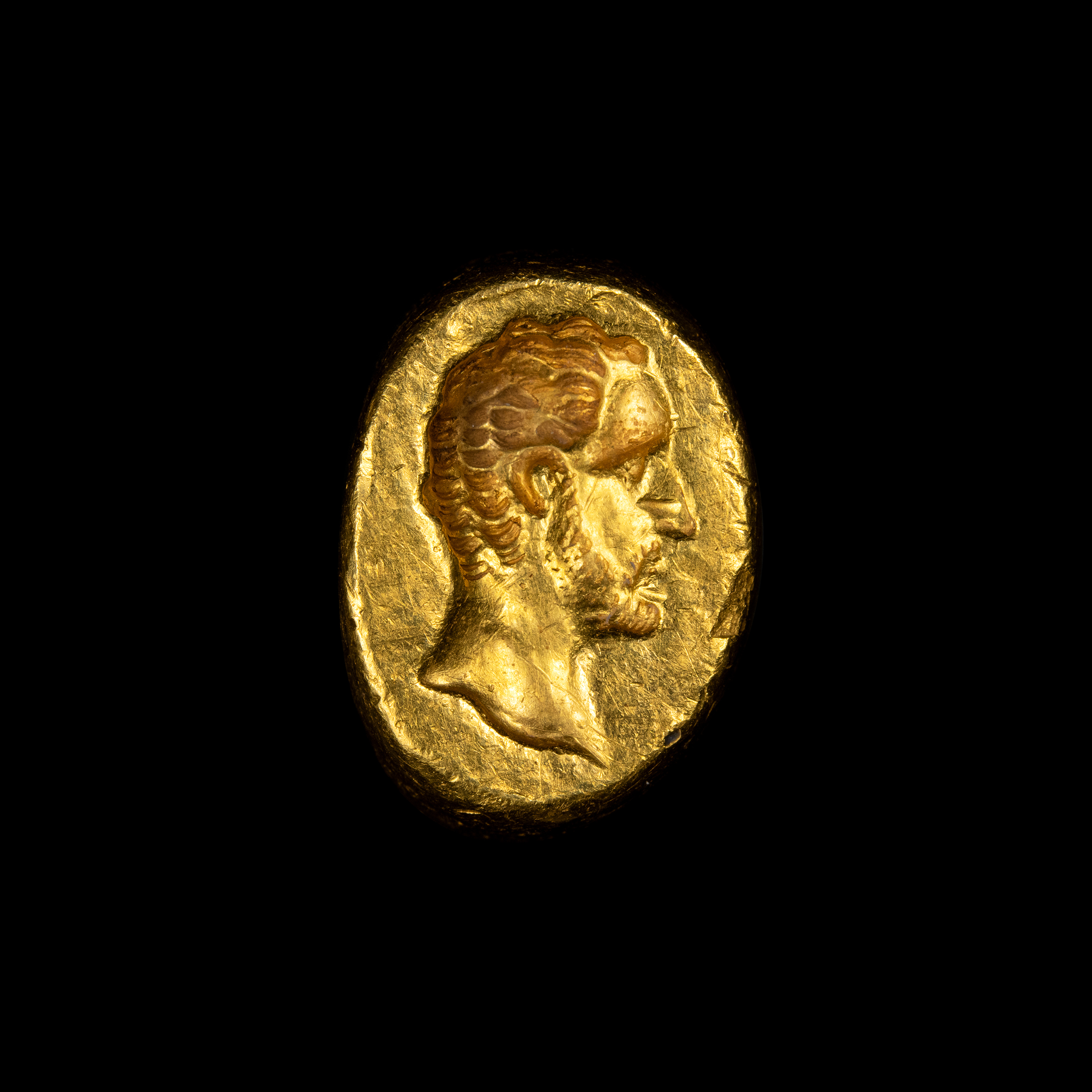 *A Roman gold engraved ring. Male portrait. 